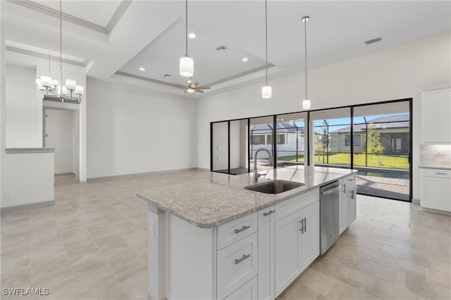 kitchen featuring a tray ceiling, dishwasher, sink, and white cabinets