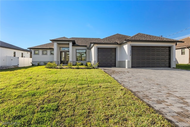 view of front of property featuring a front yard and a garage