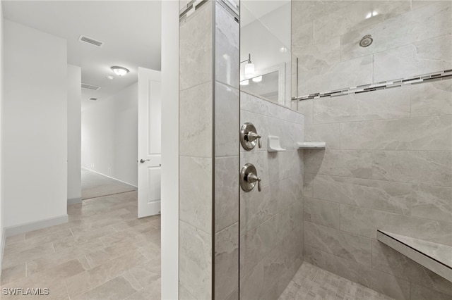 bathroom featuring a tile shower