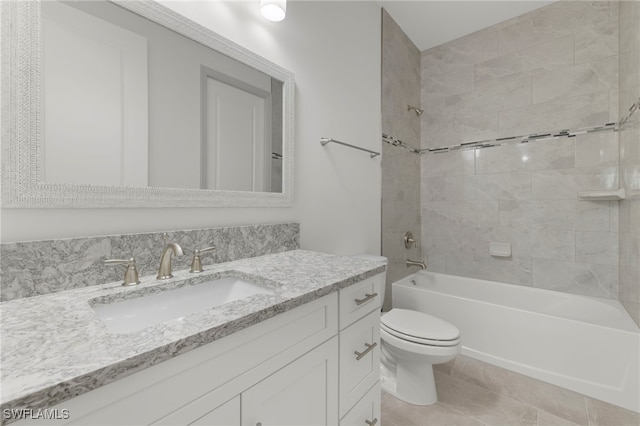 full bathroom featuring toilet, vanity, tile patterned floors, and tiled shower / bath