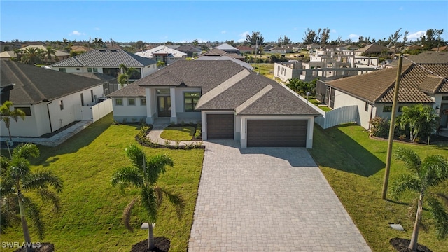 view of front of home featuring a front yard and a garage