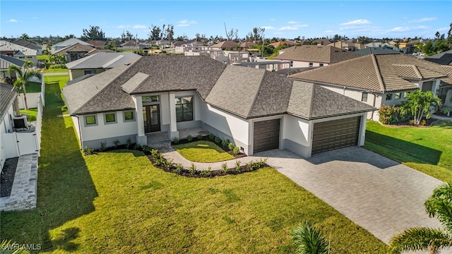 view of front of property with a front yard and a garage