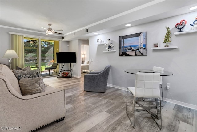 living room featuring hardwood / wood-style flooring and ceiling fan