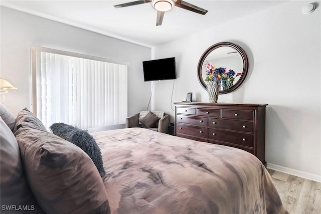 bedroom with ceiling fan and light wood-type flooring