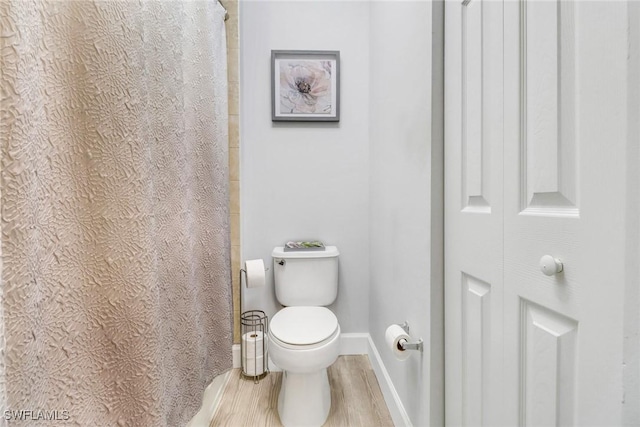 bathroom featuring hardwood / wood-style floors and toilet