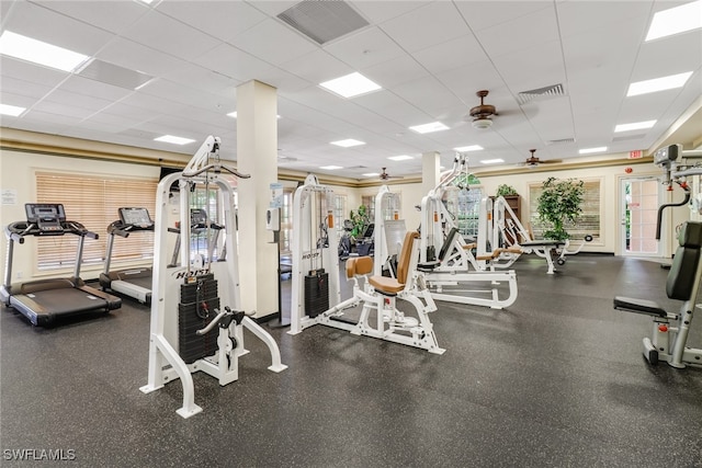 exercise room featuring a paneled ceiling and ceiling fan