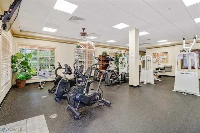 gym featuring a drop ceiling and ceiling fan