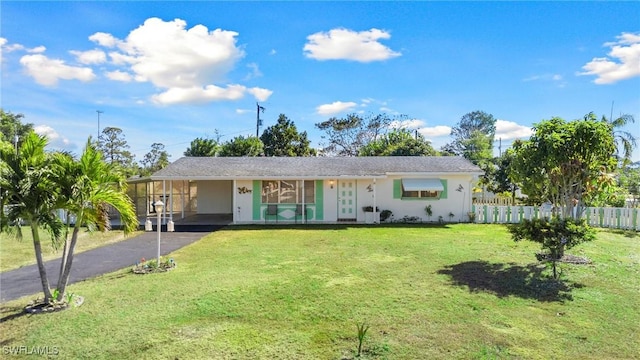 single story home featuring a carport and a front lawn