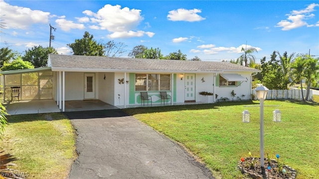 ranch-style house with a front yard and a carport