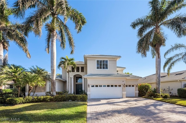 mediterranean / spanish-style house with a garage and a front yard