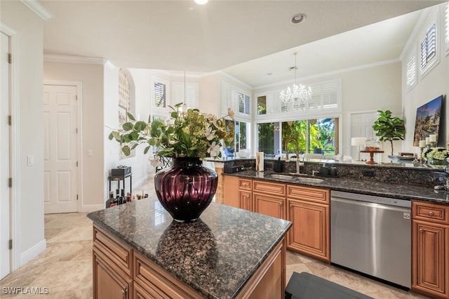 kitchen with sink, an inviting chandelier, stainless steel dishwasher, dark stone countertops, and decorative light fixtures