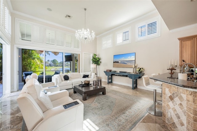 living room featuring ornamental molding, a towering ceiling, and a notable chandelier