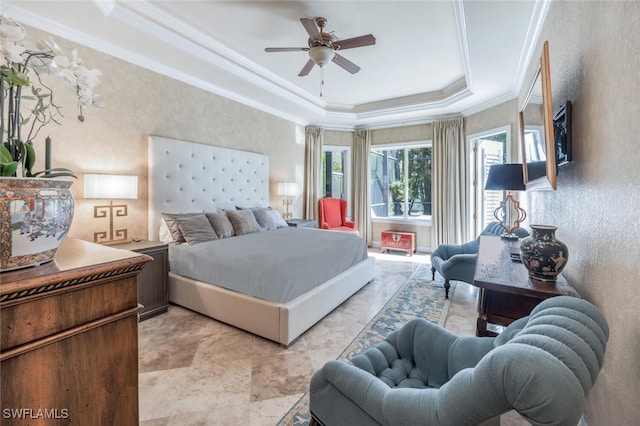 bedroom with a tray ceiling, ceiling fan, and crown molding