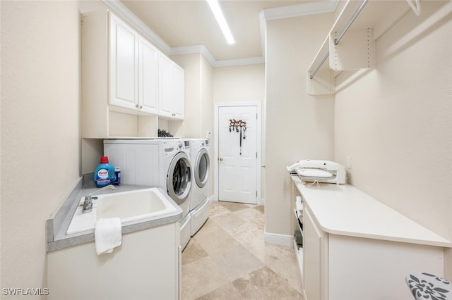 washroom featuring sink, cabinets, separate washer and dryer, and ornamental molding