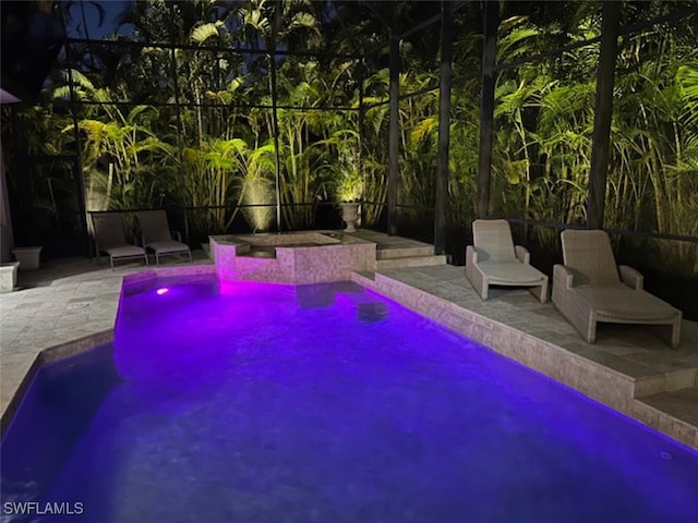 view of swimming pool featuring a lanai and a patio