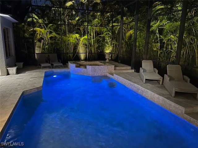 view of swimming pool with glass enclosure and a patio