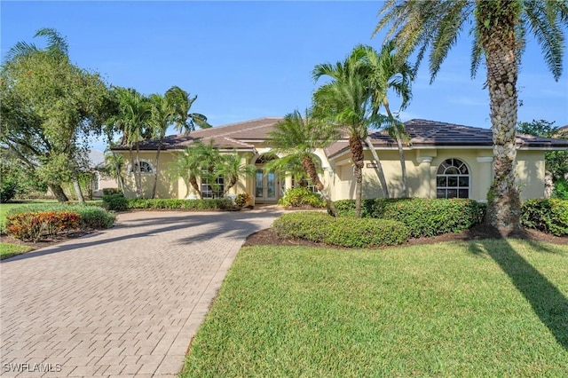 mediterranean / spanish-style home featuring a front yard