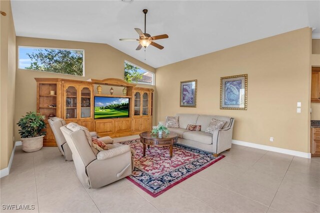 tiled living room featuring ceiling fan and high vaulted ceiling