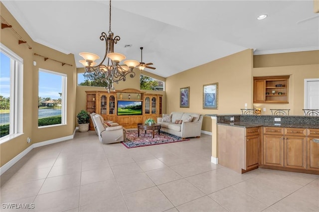 tiled living room featuring crown molding, ceiling fan with notable chandelier, a healthy amount of sunlight, and lofted ceiling