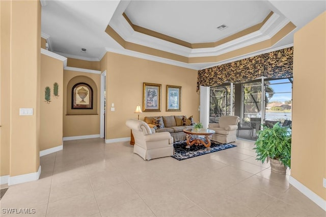 tiled living room with a raised ceiling and ornamental molding