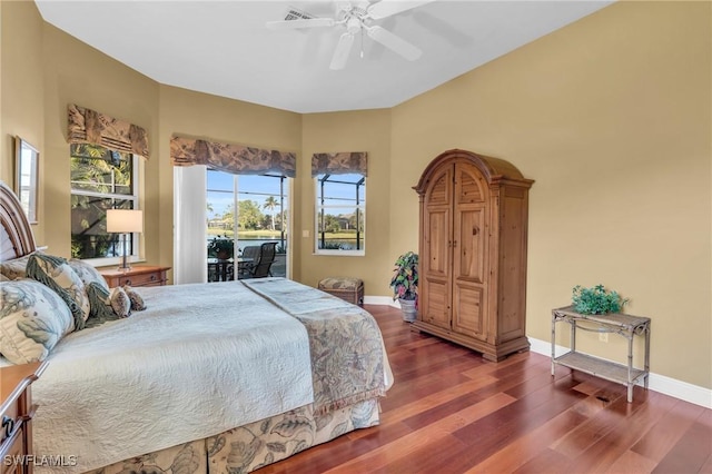 bedroom with access to outside, dark hardwood / wood-style floors, and ceiling fan