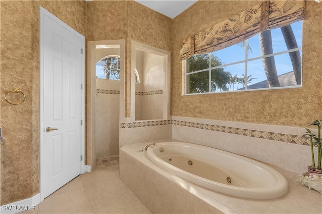 bathroom featuring tile patterned floors and separate shower and tub