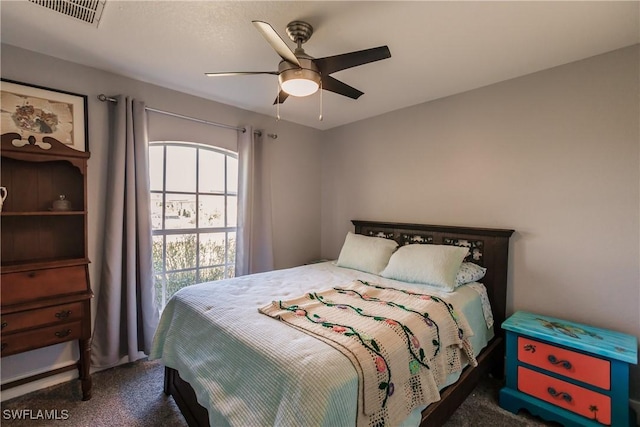 bedroom featuring dark colored carpet and ceiling fan