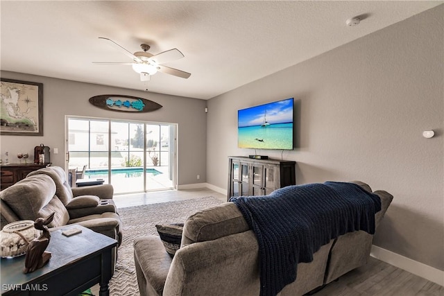 living room with hardwood / wood-style flooring and ceiling fan