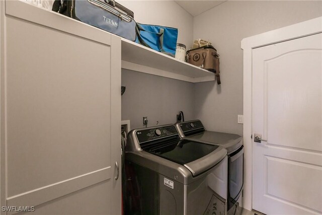 washroom with washing machine and clothes dryer