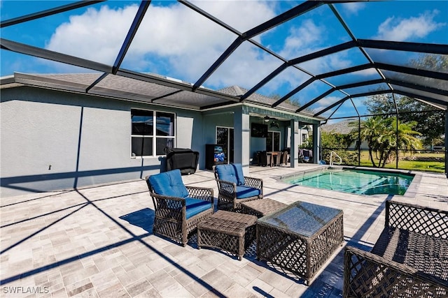 view of swimming pool with ceiling fan, a patio area, and glass enclosure