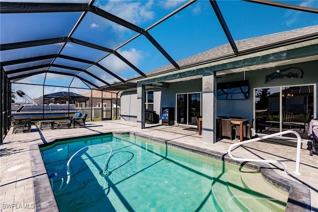 view of swimming pool featuring glass enclosure and a patio area