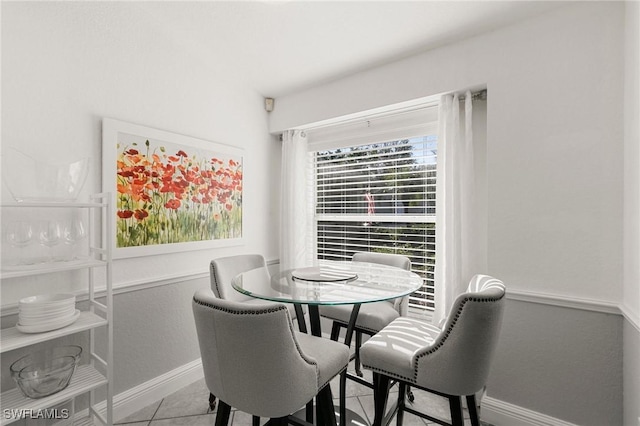 dining space with tile patterned flooring