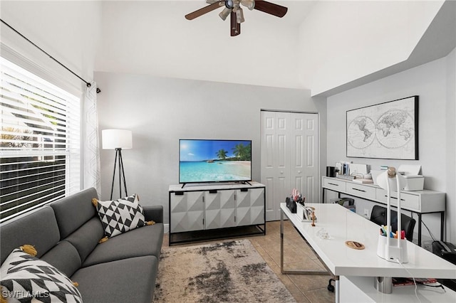 tiled living room with vaulted ceiling and ceiling fan