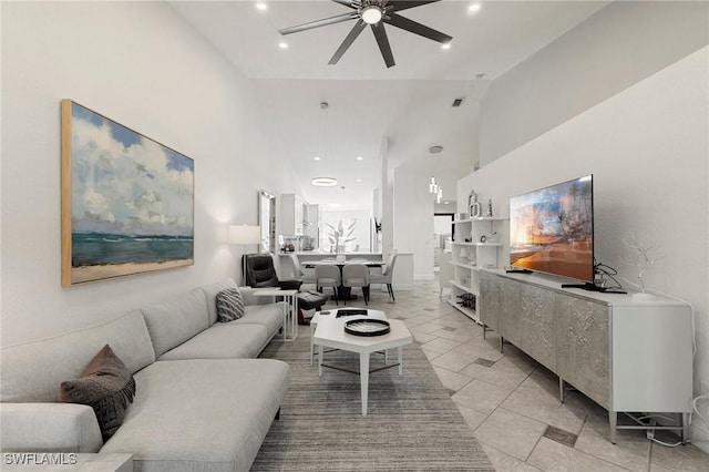 living room with ceiling fan and high vaulted ceiling