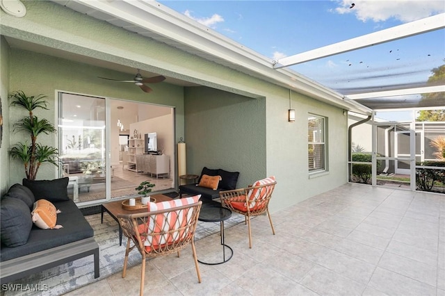 view of patio / terrace featuring an outdoor living space, ceiling fan, and a lanai