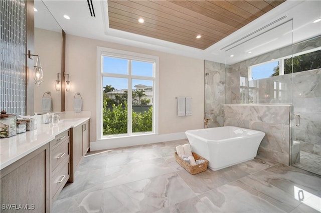 bathroom featuring marble finish floor, wooden ceiling, a raised ceiling, and a healthy amount of sunlight