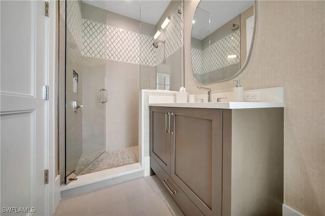 bathroom with a stall shower, tile patterned flooring, and vanity