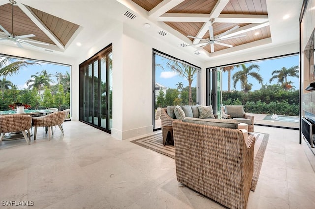 interior space featuring a ceiling fan, visible vents, plenty of natural light, and coffered ceiling