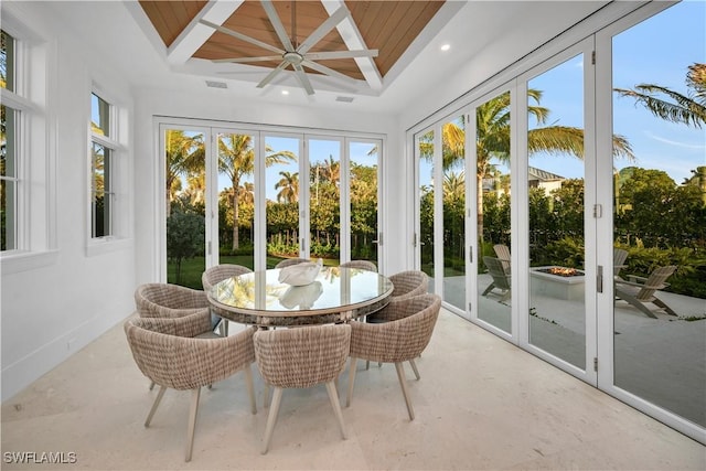 sunroom featuring a wealth of natural light, beam ceiling, and visible vents