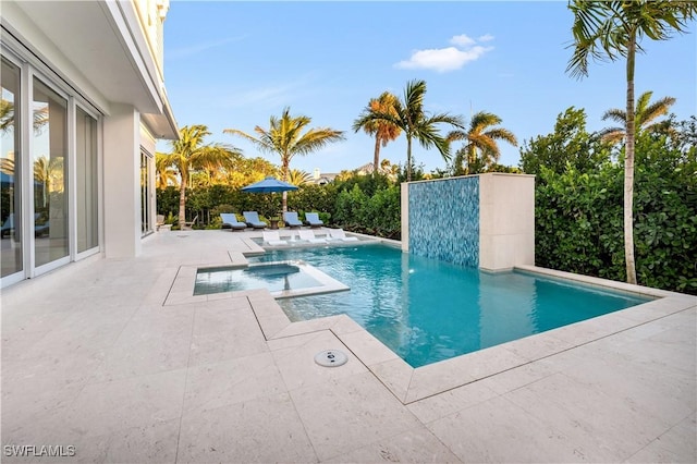 view of pool featuring a pool with connected hot tub and a patio