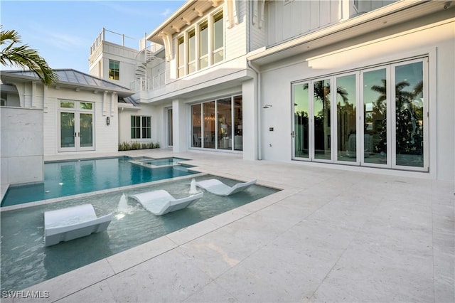 view of pool with a patio, french doors, and a pool with connected hot tub