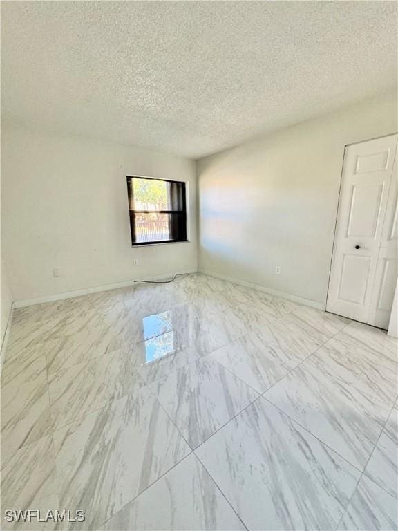 empty room with a textured ceiling