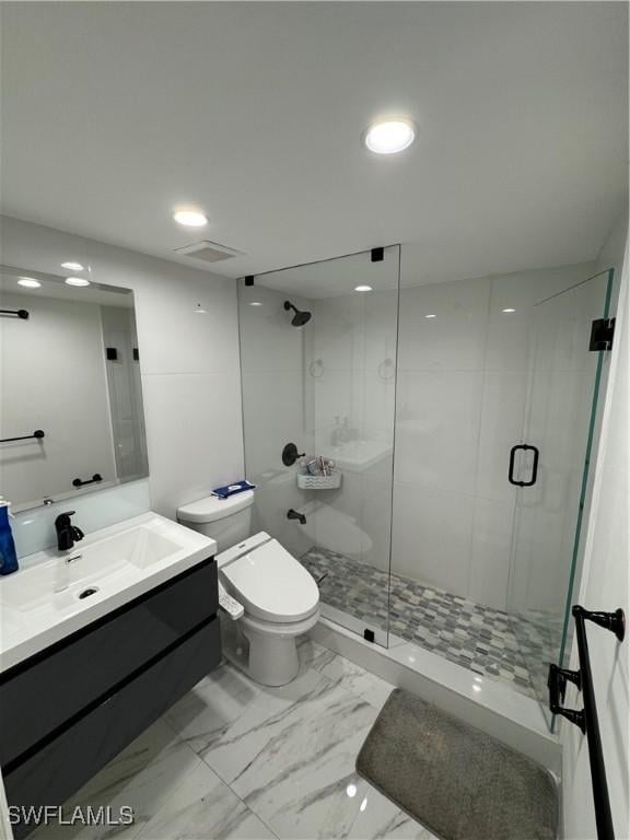 bathroom with vanity, toilet, and an enclosed shower