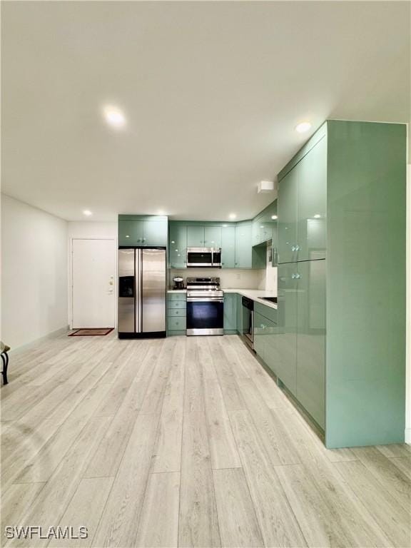 kitchen with stainless steel appliances and light hardwood / wood-style flooring