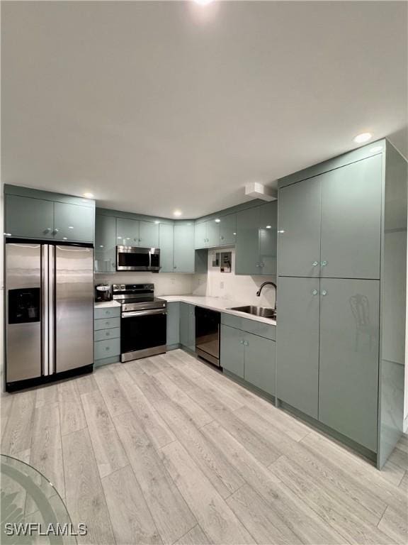 kitchen featuring sink, stainless steel appliances, and light wood-type flooring