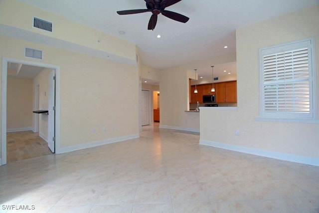 unfurnished living room with ceiling fan and sink