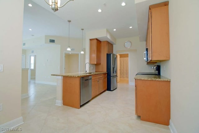 kitchen with kitchen peninsula, pendant lighting, stainless steel appliances, and sink