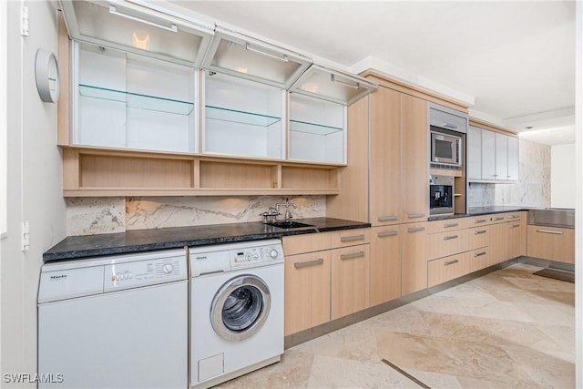 kitchen with light brown cabinetry, sink, washer and clothes dryer, and appliances with stainless steel finishes