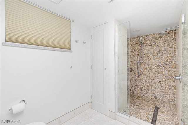 bathroom with a tile shower