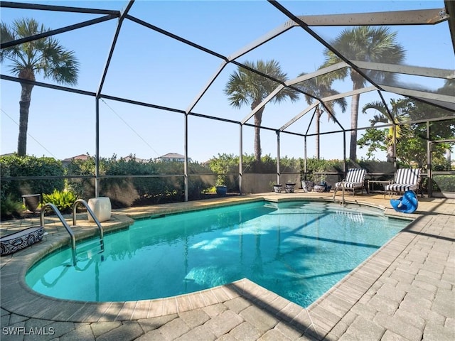 view of pool featuring a patio and glass enclosure